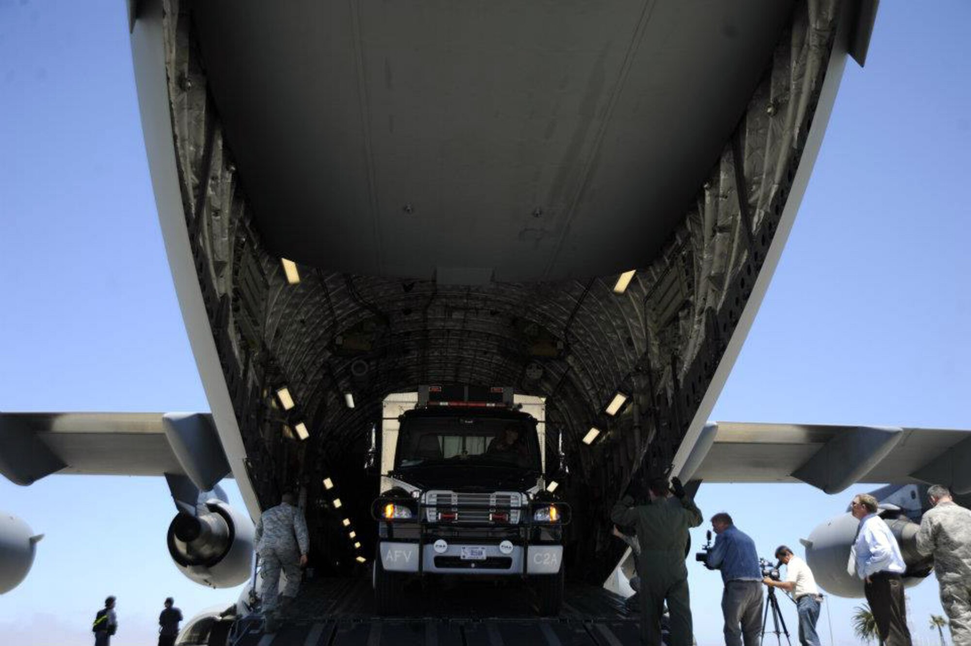 A Vandenberg Air Force Base Hot Shots vehicle backs into the belly of a March Air  Reserve Base, Calif., C-17 Globemaster III at Vandenberg AFB, Calif., on June 27, 2012. Eighteen members of the Vandenberg Hot Shots crew, along with two crew carrier vehicles, one superintendent support vehicle and one all terrain vehicle, deployed to Colorado to support the wild land fire-fighting efforts. (U.S. Air Force photo by Staff Sgt. Andrew Satran)