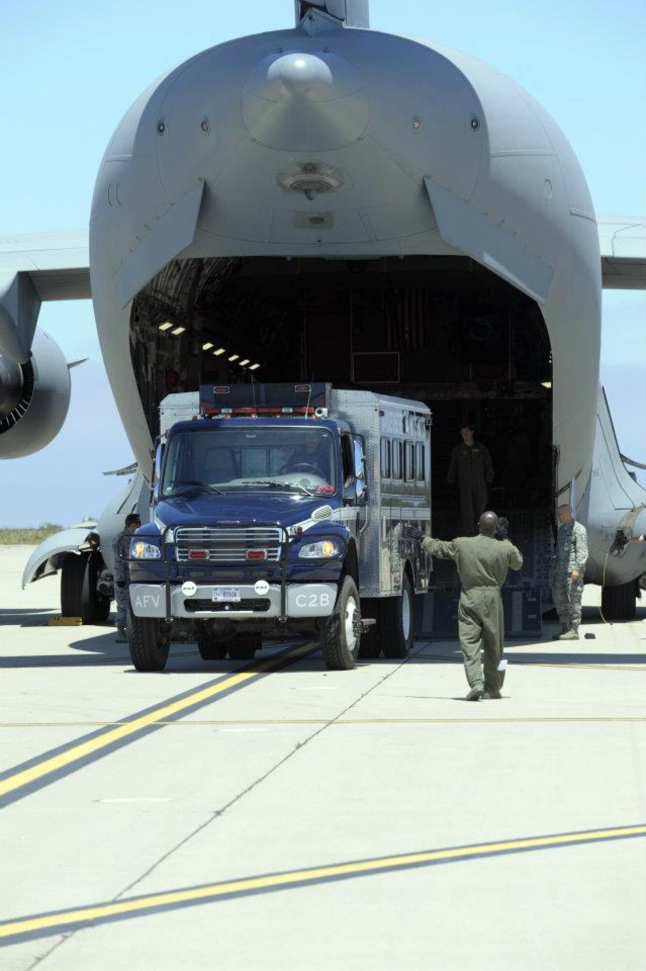A Vandenberg Air Force Base Hot Shots vehicle backs into the belly of a March Air  Reserve Base, Calif., C-17 Globemaster III at Vandenberg AFB, Calif., on June 27, 2012. Eighteen members of the Vandenberg Hot Shots crew, along with two crew carrier vehicles, one superintendent support vehicle and one all terrain vehicle, deployed to Colorado to support the wild land fire-fighting efforts. (U.S. Air Force photo by Staff Sgt. Andrew Satran)