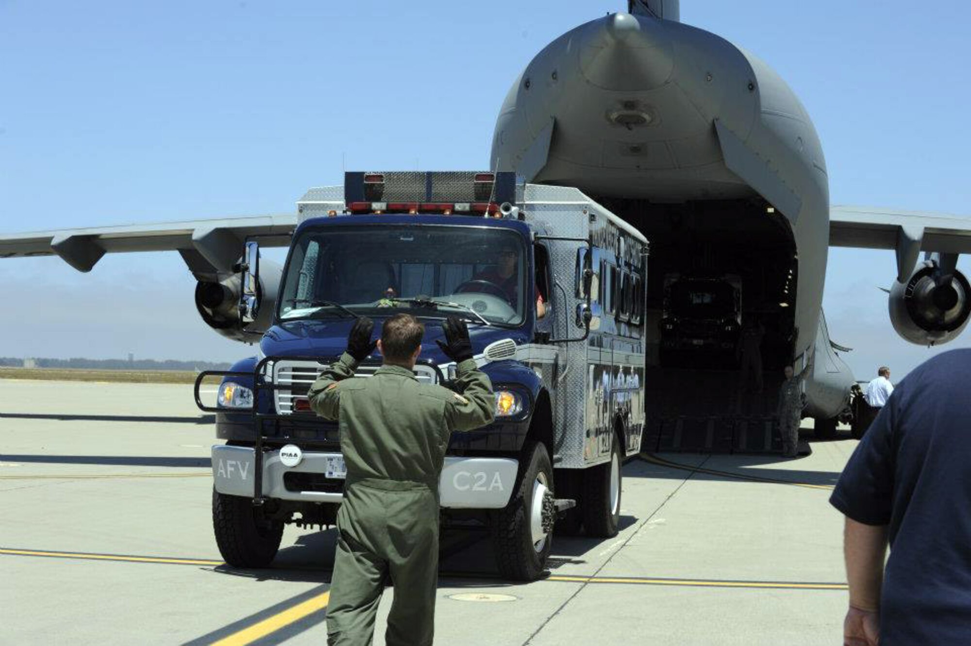 A Vandenberg Air Force Base Hot Shots vehicle backs into the belly of a March Air  Reserve Base, Calif., C-17 Globemaster III at Vandenberg AFB, Calif., on June 27, 2012. Eighteen members of the Vandenberg Hot Shots crew, along with two crew carrier vehicles, one superintendent support vehicle and one all terrain vehicle, deployed to Colorado to support the wild land fire-fighting efforts. (U.S. Air Force photo by Staff Sgt. Andrew Satran)
