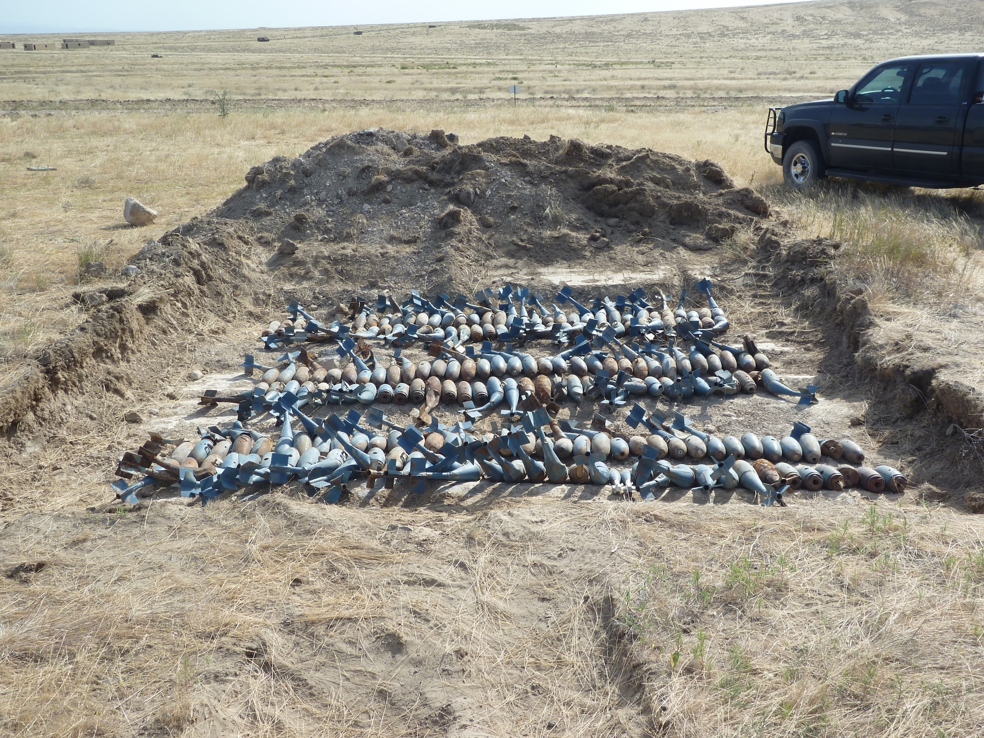 Munitions are laid out before being safety demolished by the 366th Civil Engineer Squadron’s explosive ordnance disposal Airmen June 22, 2012, inside the Saylor Creek range area of Mountain Home Air Force Base, Idaho. Mountain Home AFB, along with eight other Air Force installations, used this time as an “initial range clearance” qualification for EOD 5 level certifications. (U.S. Air Force photo/Tech. Sgt. Robert Humphus)