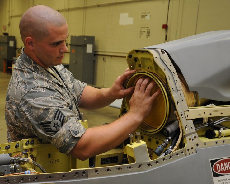 Staff Sgt. Keith Carpenter, 2nd Munitions Squadron cruise missile flight instructor, installs a cover on the back side of an Air to Ground Missile-86C engine inlet on Barksdale Air Force Base, La., July 2. This is routinely done to prevent degradation of the operational capability of the engine during start-up and launch. It also safeguards against foreign object damage. (U.S. Air Force photo/Senior Airman Sean Martin)(Released)