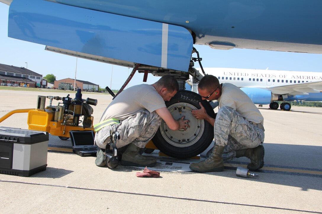 Staff Sgts. Dan Durbin (left) and Jason Johnson install a new front tire on a C-40C on a sweltering afternoon at Scott Air Force Base, Ill.  Durbin and Johnson are reservists assigned to the 932nd Maintenance Squadron.  The 932nd Airlift Wing is only Air Force Reserve unit that flies the C-40C.  (U.S. Air Force photo/Tech. Sgt. Dan Oliver)