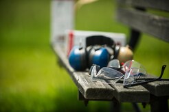 Safety gear, including safety glasses and hearing protection, rest on a bench near the shooting range during a skeet and trap shoot at Joint Base Charleston - Air Base, S.C., July 11, 2012. The Airmen participated in a skeet and trap shoot sponsored by the Single Airman Initiative Program, which aims to build camaraderie among Airmen and leadership while increasing communication and understanding. (U.S. Air Force photo by Airman 1st Class George Goslin/Released)