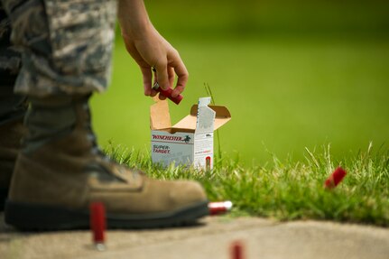 Airman 1st Class Chris Curry, 628th Logistics Readiness Squadron customer service journeyman, grabs shells to reload his shotgun during a skeet and trap shoot at Joint Base Charleston - Air Base, S.C., July 11, 2012. The Airmen participated in a skeet and trap shoot sponsored by the Single Airman Initiative Program, which aims to build camaraderie among Airmen and leadership while increasing communication and understanding. (U.S. Air Force photo by Airman 1st Class George Goslin/Released)