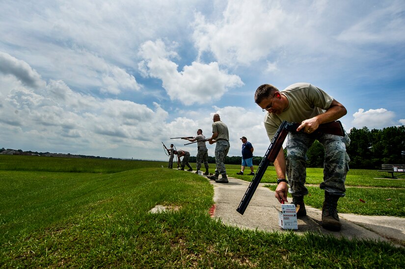 Lt. Col. David Schlevensky, 628th Medical Support Squadron commander, grabs shells for his shotgun during a skeet and trap shoot at Joint Base Charleston - Air Base, S.C., July 11, 2012. The Airmen participated in a skeet and trap shoot sponsored by the Single Airman Initiative Program, which aims to build camaraderie among Airmen and leadership while increasing communication and understanding. (U.S. Air Force photo by Airman 1st Class George Goslin/Released)
