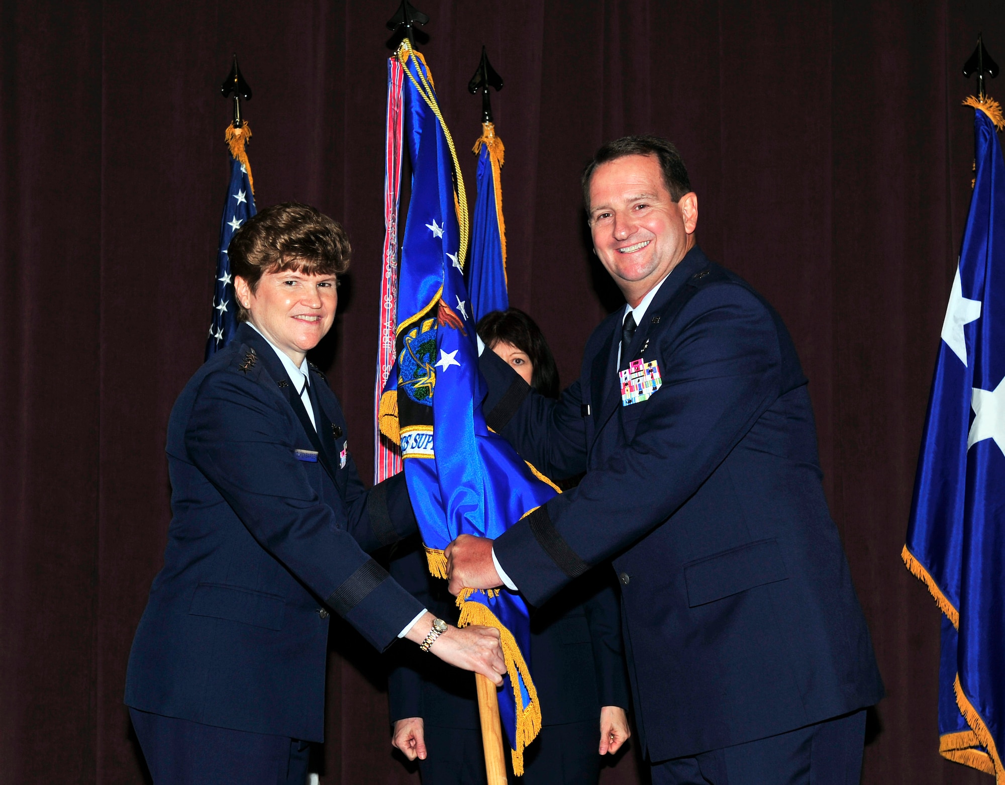 Brig. Gen Brent Baker, Air Force Global Logistics Support Center commander, 
passes the AFGLSC  flag to Gen. Janet Wolfenbarger, Air Force Material Command 
commander, as AFGLSC officially becomes part of the Air Force Sustainment 
Center July 11, 2012. The AFGLSC was established on March 28, 2008. Lt. Gen 
Bruce Litchfield will lead the newly designated AFSC at Tinker Air Force Base, 
Okla. (U.S. Air Force photo/ Staff Sgt. Stephenie Wade)

