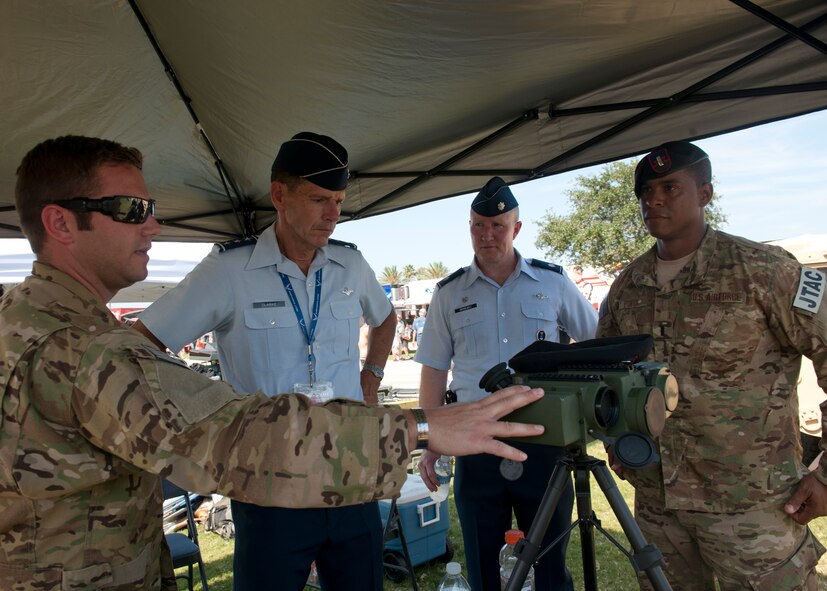 Airmen with the 15th Air Support Operations Squadron show some of their job equipment to U.S. Air Force Lt. Gen. Stanley Clarke, Continental U.S. North American Aerospace Defense Command Region – 1st Air Force (Air Forces Northern) commander, at the Daytona International Speedway July 7, 2012, at Daytona Beach, Fla. The 15th ASOS also brought a Mine Resistant Ambush Protected vehicle along with Tactical Air Control Party replicated training equipment. (U.S. Air Force photo by Senior Airman Eileen Meier/Released)