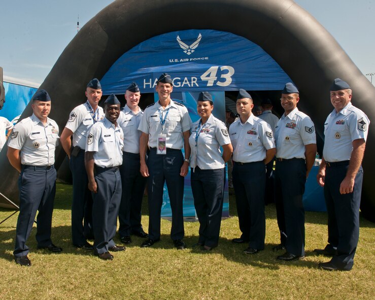 Members of the 336th Recruiting Squadron gather for a group photo with U.S. Air Force Lt. Gen. Stanley Clarke, Continental U.S. North American Aerospace Defense Command Region – 1st Air Force (Air Forces Northern) commander in front of “Hangar 43,” the Air Force display at the Daytona International Speedway July 7, 2012, at Daytona Beach, Fla.  Forty-three is the number of NASCAR racer Aric Almirola’s car, which is sponsored by the Air Force. The 336th RCS used the display to hand out memorabilia and lithographs of the Air Force and Almirola. (U.S. Air Force photo by Senior Airman Eileen Meier/Released)
