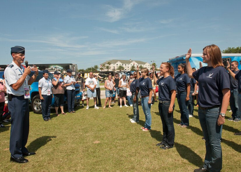 U.S. Air Force Lt. Gen. Stanley Clarke, Continental U.S. North American Aerospace Defense Command Region – 1st Air Force (Air Forces Northern) commander, administers the Oath of Enlistment to members of the delayed entry program at the Daytona International Speedway July 7, 2012, at Daytona Beach, Fla. Family, friends and Daytona fans gathered to witness the future Airmen make the commitment to serve the country. (U.S. Air Force photo by Senior Airman Eileen Meier/Released)