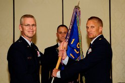 Brig. Gen. Les Kodlick, Director of Public Affairs, Office of the Secretary of the Air Force, the Pentagon, Washington D.C., passes the squadron guidon to Maj. Michael Johnson, 1st Combat Camera Squadron incoming commander, during the 1st CTCS Change of Command ceremony at Joint Base Charleston - Air Base, S.C., July 10. (U.S. Air Force photo by Senior Airman Alexandra Hoachlander/Released)