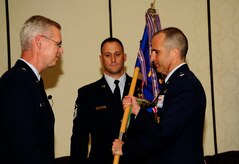 Brig. Gen. Les Kodlick, Director of Public Affairs, Office of the Secretary of the Air Force, the Pentagon, Washington D.C., prepares to take the squadron guidon from Lt. Col. Aaron Burgstein, 1st Combat Camera Squadron outgoing commander, during the 1st CTCS Change of Command ceremony at Joint Base Charleston - Air Base, S.C., July 10. (U.S. Air Force photo by Senior Airman Alexandra Hoachlander/Released)