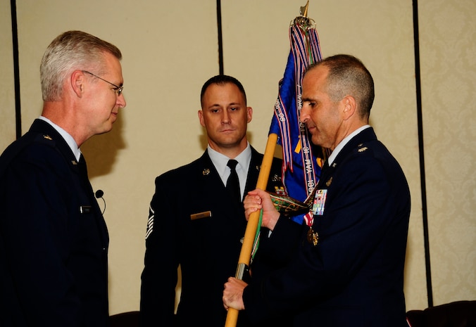 U.S. Air Force Lt. Col. Aaron Burgstien relinquishes command of the 1st Combat Camera Squadron to U.S. Air Force Brig. Gen. Les Kodlick, Office of the Secretary of the Air Force Director of Public Affairs, during a change of command ceremony at Joint Base Charleston, S.C., July 10. (U.S. Air Force Photo by Senior Airman Alexandra Hoachlander/ Released)
