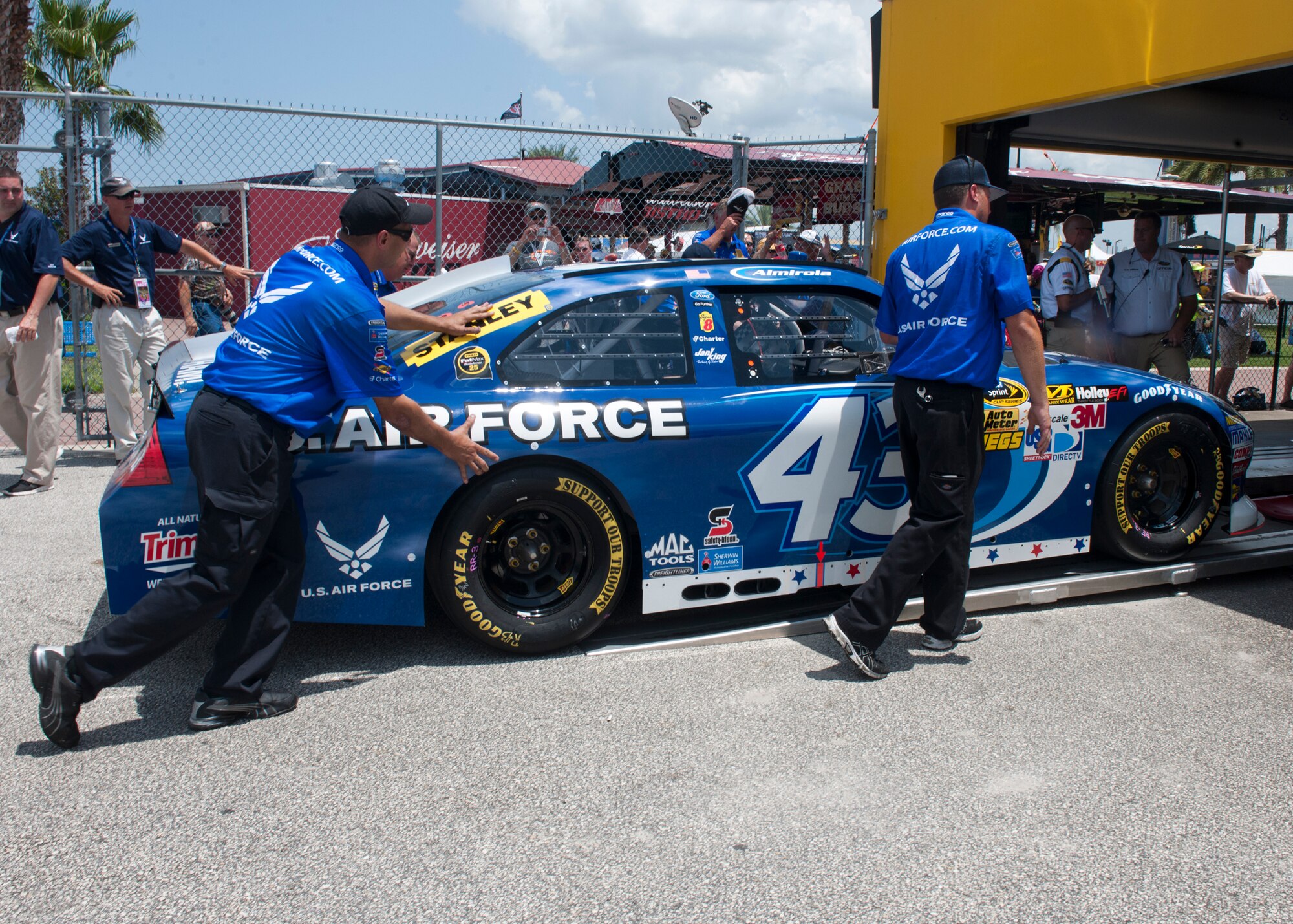 Members of Aric Almirola’s NASCAR pit crew push his car into the first pre-race inspection line at the Daytona International Speedway July 7, 2012, at Daytona Beach Fla. These inspections are not only important for safety reasons but also to ensure the cars are equally inspected and all drivers have the same advantages in winning the race. (U.S. Air Force photo by Senior Airman Eileen Meier/Released)