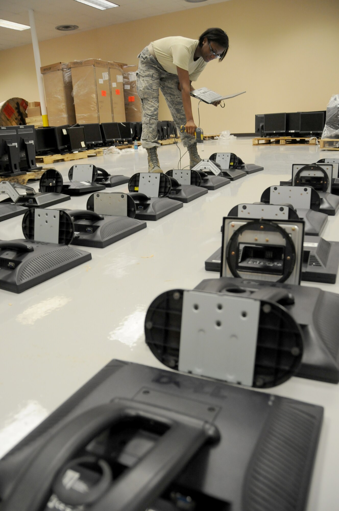 Staff Sgt. Alexis Ellsworth, 81st Medical Support Squadron, scans information technology equipment she has turned in from her squadron to verify serial numbers at the Locker House June 27, 2012, at Keesler Air Force Base, Miss. The monitor turn in is part of a program started by the 81st Communications Squadron  Management information technology section to rid the base of excess IT assets.  A total of 1200 plus monitors where turned in and transferred to other equipment custodians to be used in their squadrons or donated to local schools. (U.S. Air Force photo by Kemberly Groue)