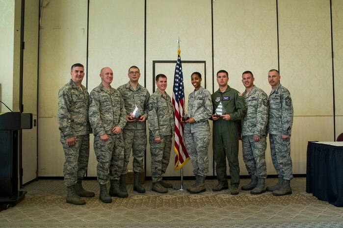 Col. Al Miller, 437th Airlift Wing vice commander, and Chief Master Sgt. Larry Williams, 437th AW command chief, pose for a photo with the Diamond Sharp award winners at Joint Base Charleston - Air Base, S.C., July 10, 2012. Diamond Sharp awards are designed to recognize individuals in a unit who stand out to their first sergeant. (U.S. Air Force photo by Airman 1st Class George Goslin/Released)