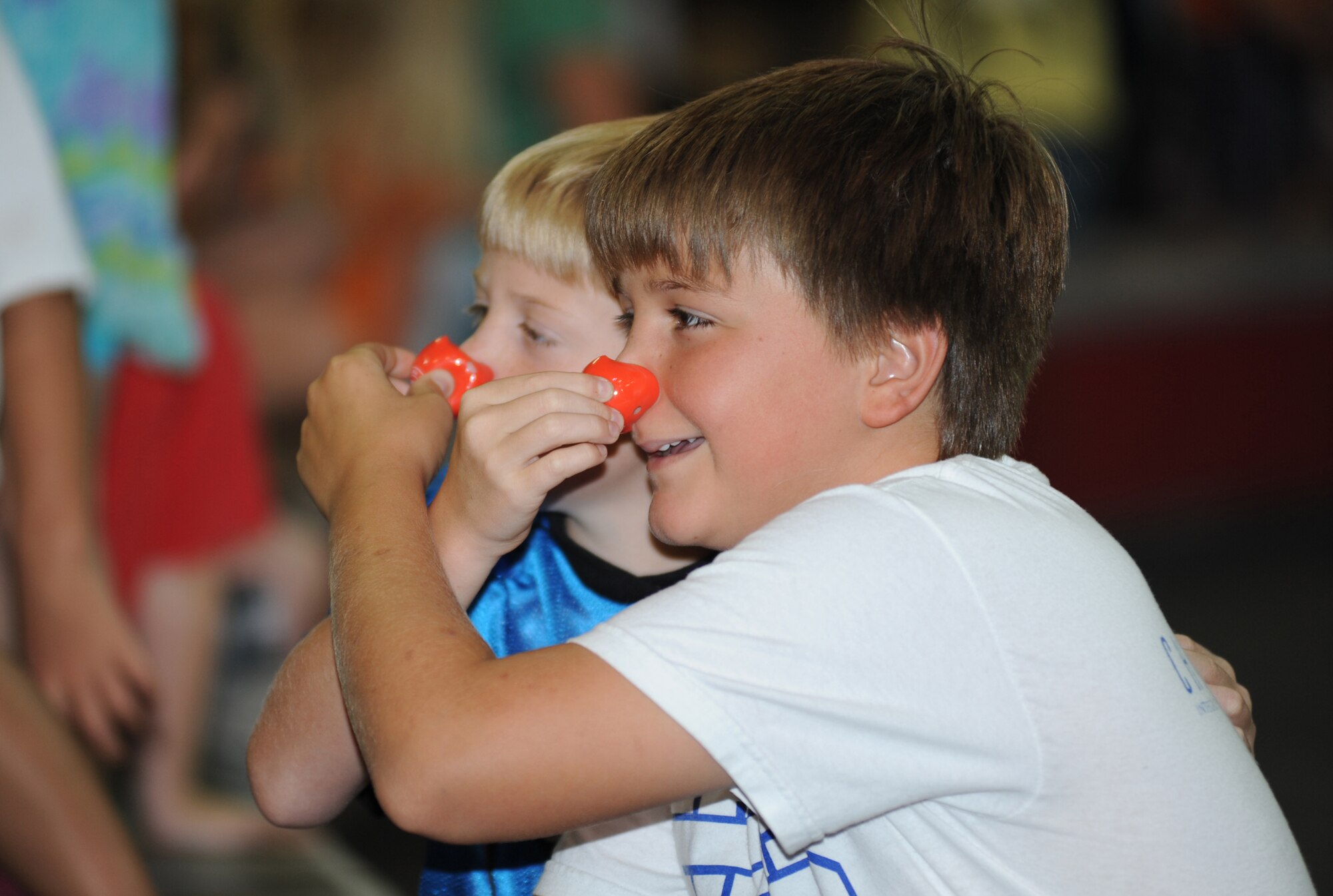 Hunter Tipton, 9, and his brother, Tanner, 11, squeeze each other’s clown nose during a Ringling Brothers and Barnum and Bailey Circus preshow at the Mississippi Coast Coliseum July 5, 2012.  The circus invited the children of deployed troops from Keesler Air Force Base, Miss., to learn about circus style exercises and received healthy eating tips that their elephants follow.  They also received free tickets to the show.  Hunter and Tanner were accompanied by their father retired Tech. Sgt. Mike Tipton of Ocean Springs, Miss.  (U.S. Air Force photo by Kemberly Groue)