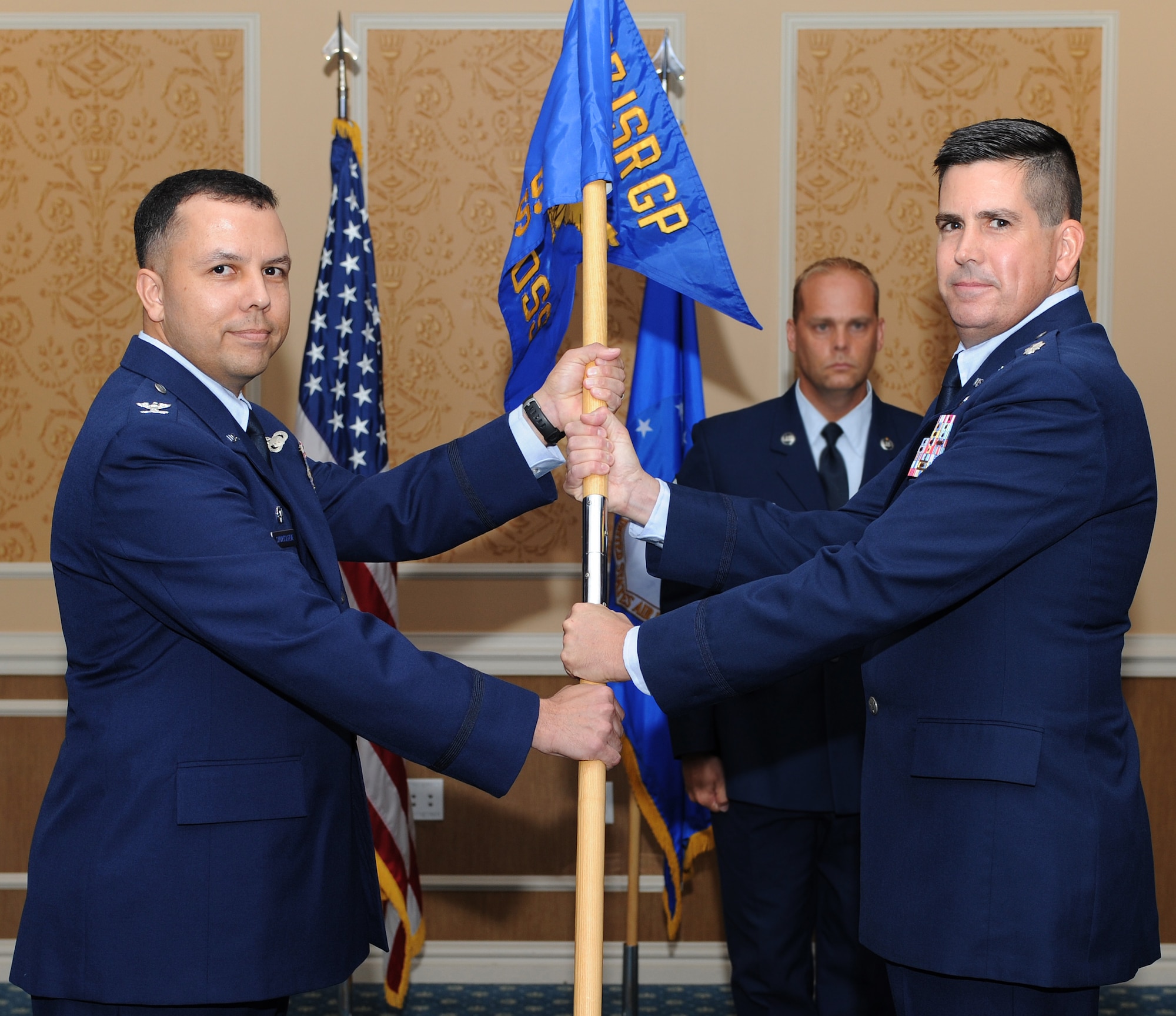 U.S. Air Force Col. Patrick Shortsleeve, 497th Intelligence, Surveillance and Reconnaissance Group commander, presents the unit guidon to Lt. Col. Ed Horner, 497th Operational Support Squadron commander, during an activation and assumption of command ceremony at Langley Air Force Base, Va., July 6, 2012. The 497th OSS will provide support for the 30th, 10th and the 45th Intelligence Squadrons once it arrives at Langley, later this year.  (U.S. Air Force photo by Airman 1st Class Teresa Cleveland/Released)