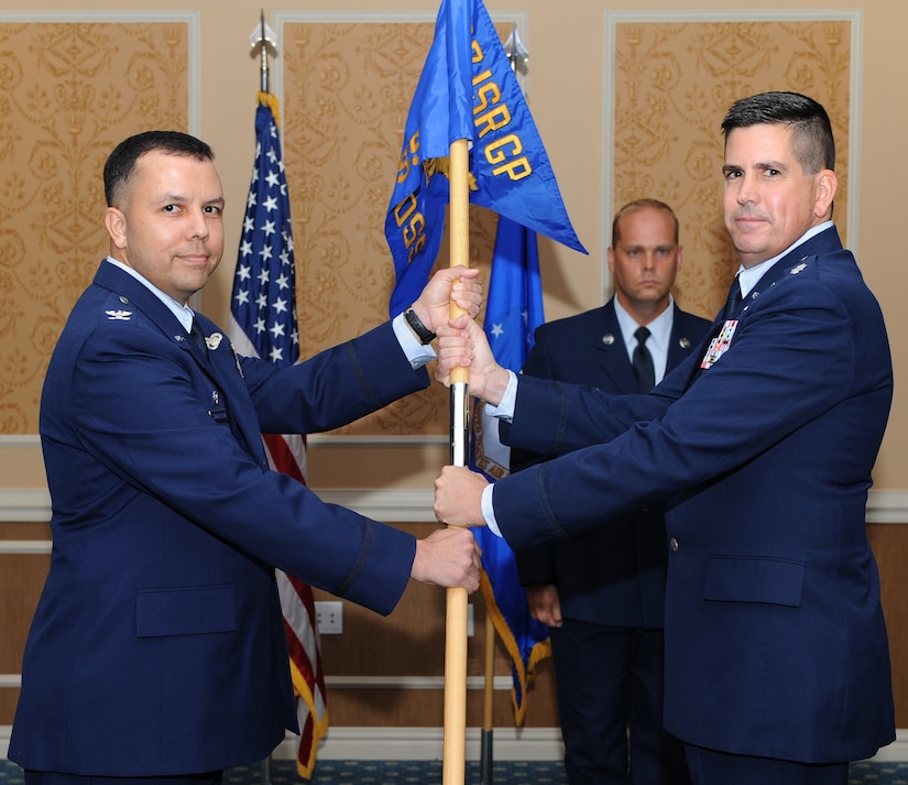 U.S. Air Force Col. Patrick Shortsleeve, 497th Intelligence, Surveillance and Reconnaissance Group commander, presents the unit guidon to Lt. Col. Ed Horner, 497th Operational Support Squadron commander, during an activation and assumption of command ceremony at Langley Air Force Base, Va., July 6, 2012. The 497th OSS will provide support for the 30th, 10th and the 45th Intelligence Squadrons once it arrives at Langley, later this year.  (U.S. Air Force photo by Airman 1st Class Teresa Cleveland/Released)
