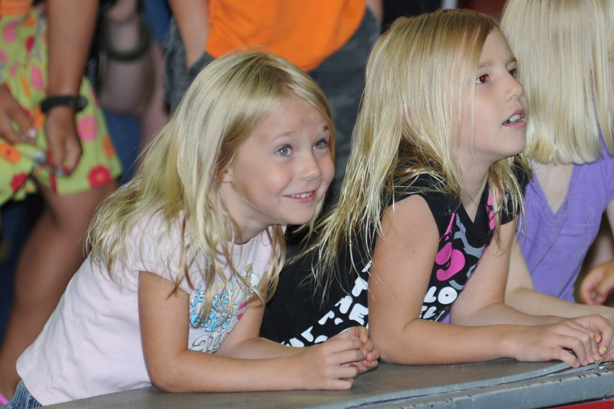 Cali Kirkbride, 5, and her sister, Saige, 7, watch as Ringling Brothers and Barnum and Bailey Circus elephants enter the arena at the Mississippi Coast Coliseum July 5, 2012. The circus invited the children to learn about circus style exercises and received healthy eating tips that their elephants follow.  They also received free tickets to the show.  Cali and Saige’s parents are Spring and Capt. Troy Kirkbride, currently assigned to Greenland.  (U.S. Air Force photo by Kemberly Groue)