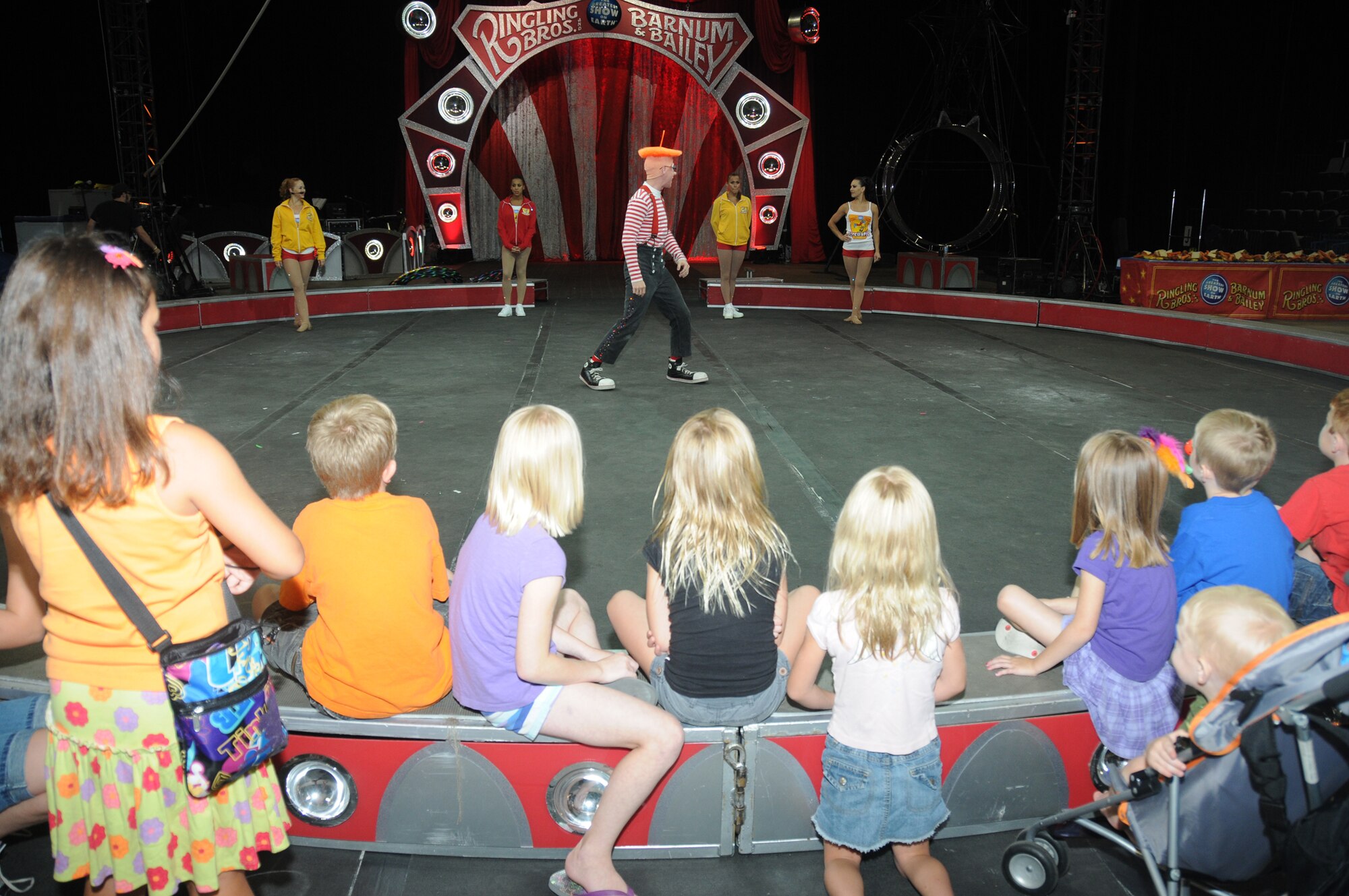 Dean the Clown, a member of the Ringling Brothers and Barnum and Bailey Circus, welcomes children of deployed troops from Keesler Air Force Base, Miss., to the Mississippi Coast Coliseum July 5, 2012, where the children learned about circus style exercises and received healthy eating tips that their elephants follow.  They also received free tickets to the show.  (U.S. Air Force photo by Kemberly Groue)