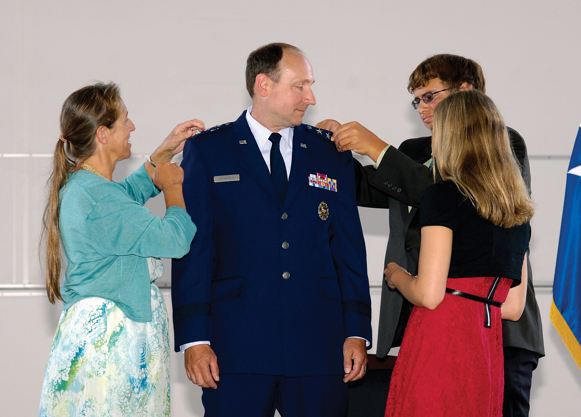 After Lt. Gen. Bruce Litchfield, Air Force Sustainment Center commander, received his third star, his wife Linda, left, son Matthew, and daughter Jennifer pin on his new rank during a ceremony held here July 10. (U.S. Air Force photo/Margo Wright) 