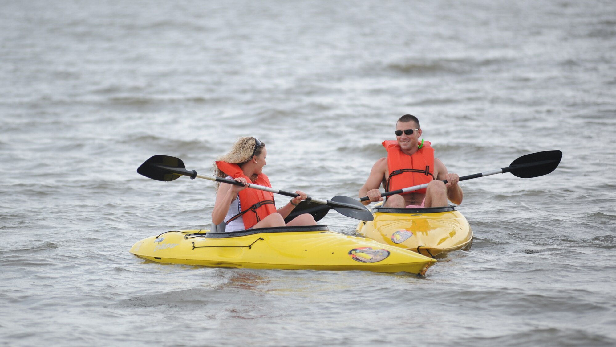 Airmen 1st Class Lisa Bugdin and Michael Montgomery, 334th Training Squadron, take kayaks out into the waters of the Gulf of Mexico during the independence day Beach Bash in Biloxi, Miss., July 4, 2012.  The event included Games, music, food, fireworks, contests and prizes.  (U.S. Air Force photo by Kemberly Groue)