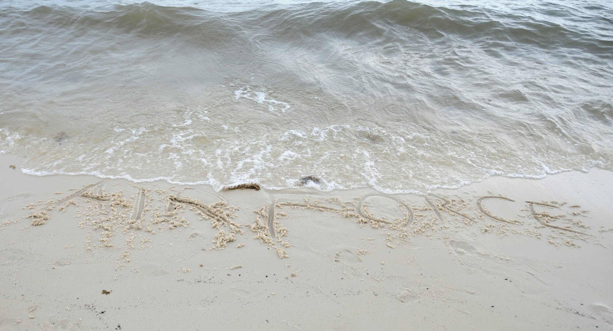 The Air Force name is drawn in the Biloxi, Miss., beach sand during the independence day Beach Bash in Biloxi, Miss., July 4, 2012.  The event included Games, music, food, fireworks, contests and prizes.  (U.S. Air Force photo by Kemberly Groue)