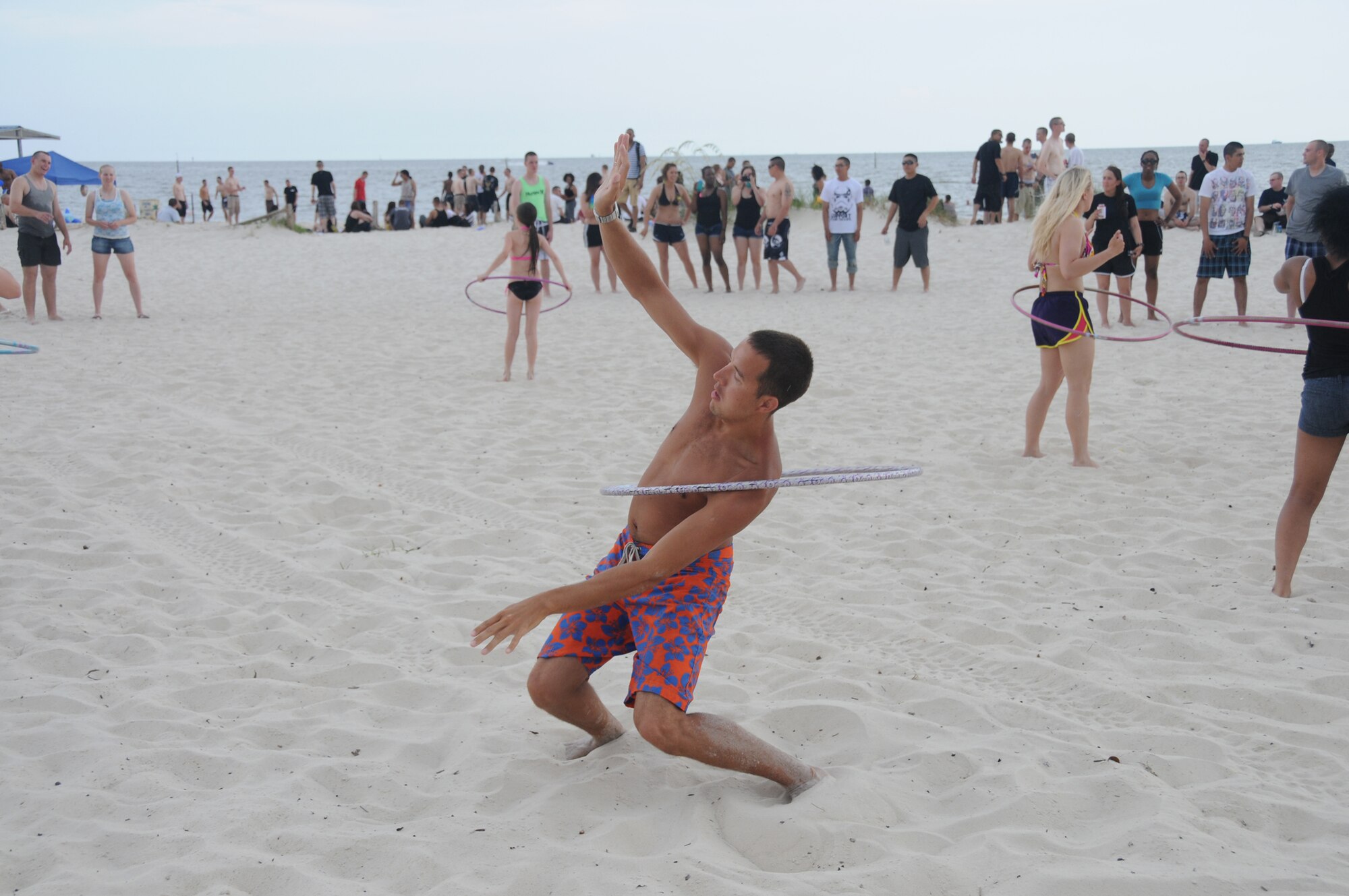 Second Lt. Jon Datsko, 335rd Training Squadron, demonstrates his hula hoop skills at the independence day Beach Bash in Biloxi, Miss., July 4, 2012. The event included Games, music, food, fireworks, contests and prizes.  (U.S. Air Force photo by Kemberly Groue)