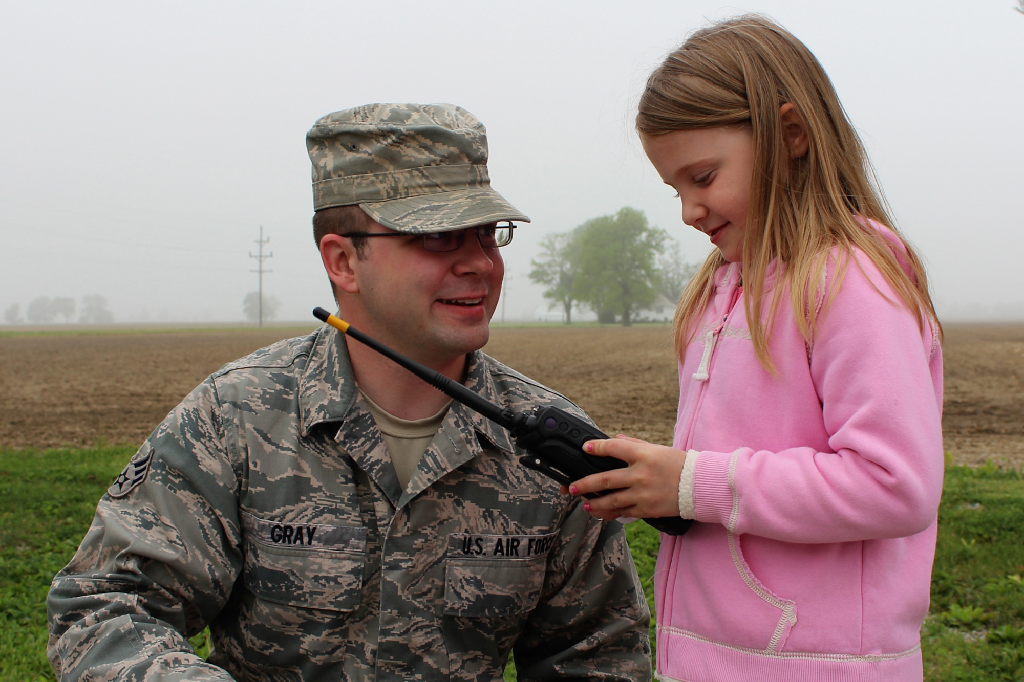 GRISSOM AIR RESERVE BASE, Ind. -- Senior Airman Zachary Gray, 434th Communications Squadron network systems journeyman, shows a local girl a land mobile radio during a training exercise in Kokomo, Ind. May 5. The exercise was meant to test the response capabilities of the emergency management team and the local Civil Air Patrol. (U.S. Air Force photo/2nd Lt. Dustin Schimp)