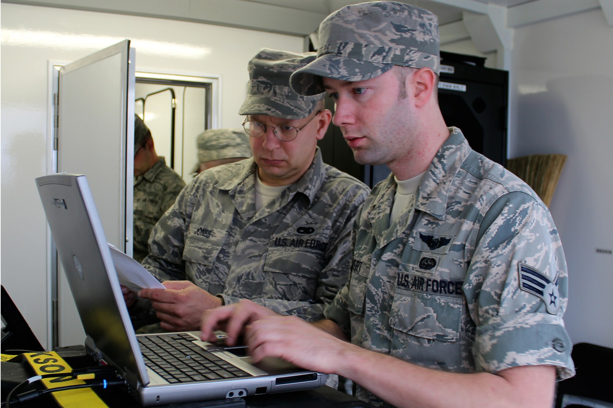 GRISSOM AIR RESERVE BASE, Ind. -- Senior Airman Ryan Covert and Staff Sgt. Timothy Jones, 434th Communications Squadron ground radio maintenance apprentices, work in the Grissom emergency management trailer during a training exercise in Kokomo, Ind. May 5. The exercise was meant to test the response capabilities of the emergency management team and the local Civil Air Patrol. (U.S. Air Force photo/2nd Lt. Dustin Schimp)