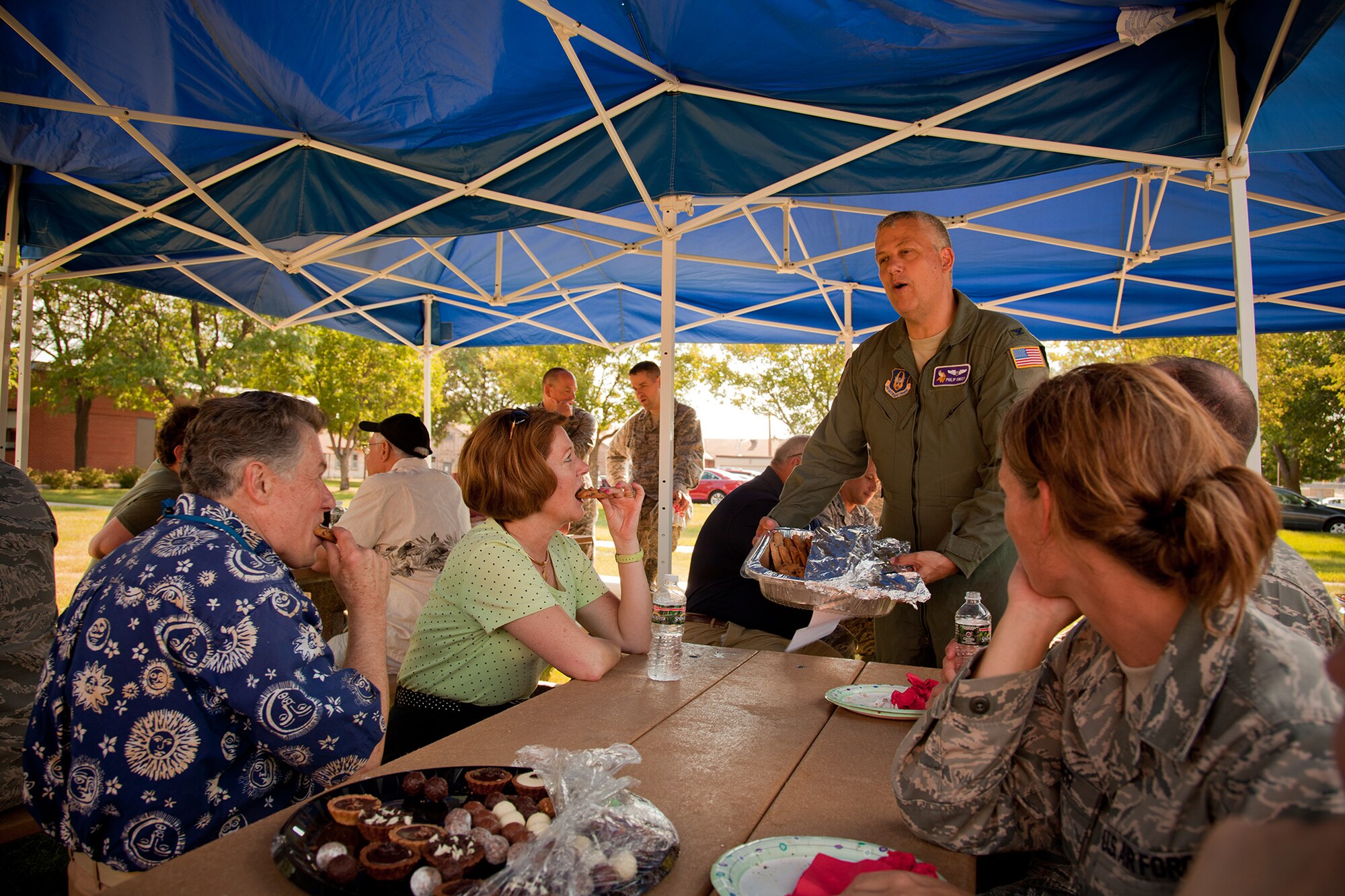 Col. Philip A. Sweet, commander of the 934th Aeromedical Staging Squadron, offers his wife's homemade cookies to Arrie Larsen-Manti, Order of the Global Viking recepient for 2012, her husband, Tom Manti, and others at the first Honorary Commanders and Base Community Council picnic July 7.  The HC and BCC programs help strengthen community partnerships with the 934th Airlift Wing, Minneapolis-St. Paul Air Reserve Station, Minn.  (U.S. Air Force Photo/Shannon McKay)