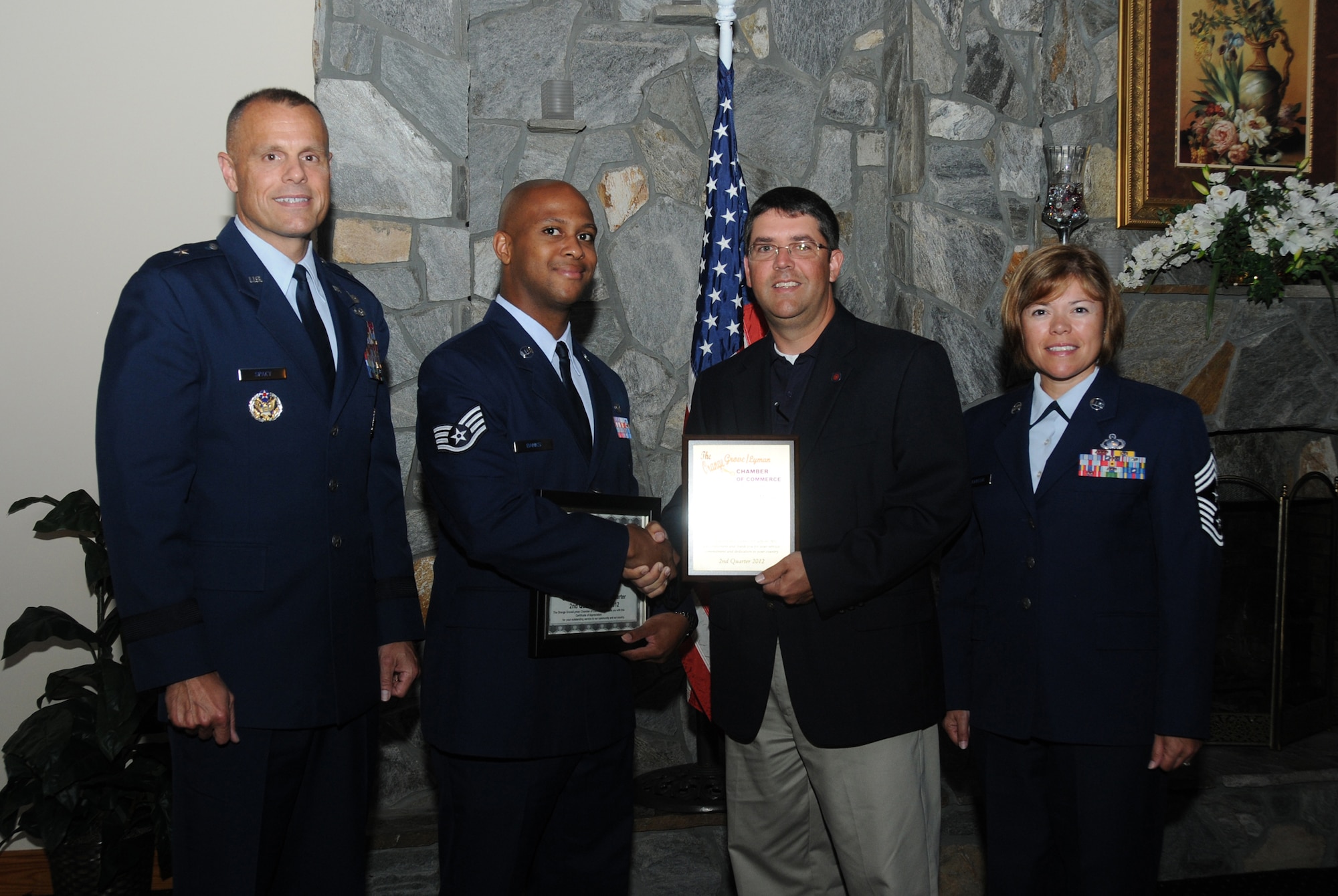 Brig. Gen. Bradley Spacy, 81st Training Wing commander; Staff Sgt. Angelo Banks, 81st Security Forces Squadron; Jay McKnight, Orange Grove/Lyman Chamber military affairs coordinator; and Chief Master Sgt. Angelica Johnson, 81 TRW command chief, pose for a photo at Orange Grove/Lyman Chamber of Commerce breakfast eye-opener June 28, 2012, in Gulfport, Miss.  Banks was recognized by the chamber as its military member of the quarter for his selection as Air Education and Training Command’s Airman of the Year for 2011.  (U.S. Air Force photo by Kemberly Groue)