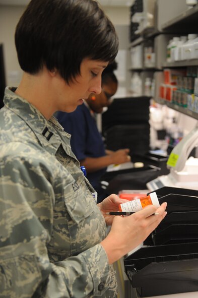U.S. Air Force Capt. Nicole Escher, 23d Medical Support Squadron pharmacy flight commander, reviews a prescription at Moody Air Force Base, Ga., July 11, 2012. The 23d Medical Group has 225 staff members who serve more than 16,000 beneficiaries with an $6.5 million annual operation budget. (U.S. Air Force photo by Staff Sgt. Ciara Wymbs/Released) 