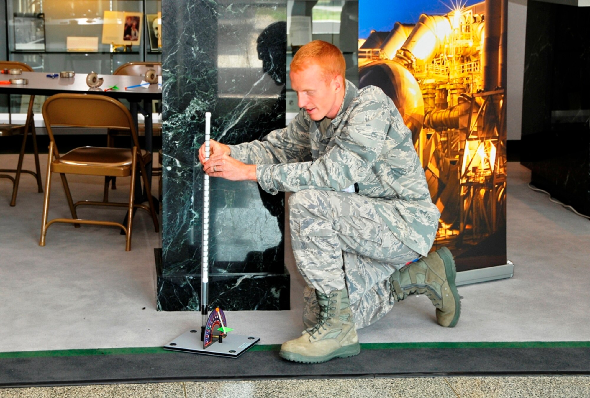 1st Lt. Bradley Chronister, AEDC’s Investments Branch lead, takes a turn at using the rocket launcher, which is used to show science basics at STEM outreach events to local kindergarten through senior high school students in surrounding communities. The rocket launcher was one of several teaching aids available to view and learn how to use during a recent presentation hosted by Jere Matty, AEDC’s STEM educational outreach specialist, in the lobby of the A&E Building. (Photo by Jacqueline Cowan)