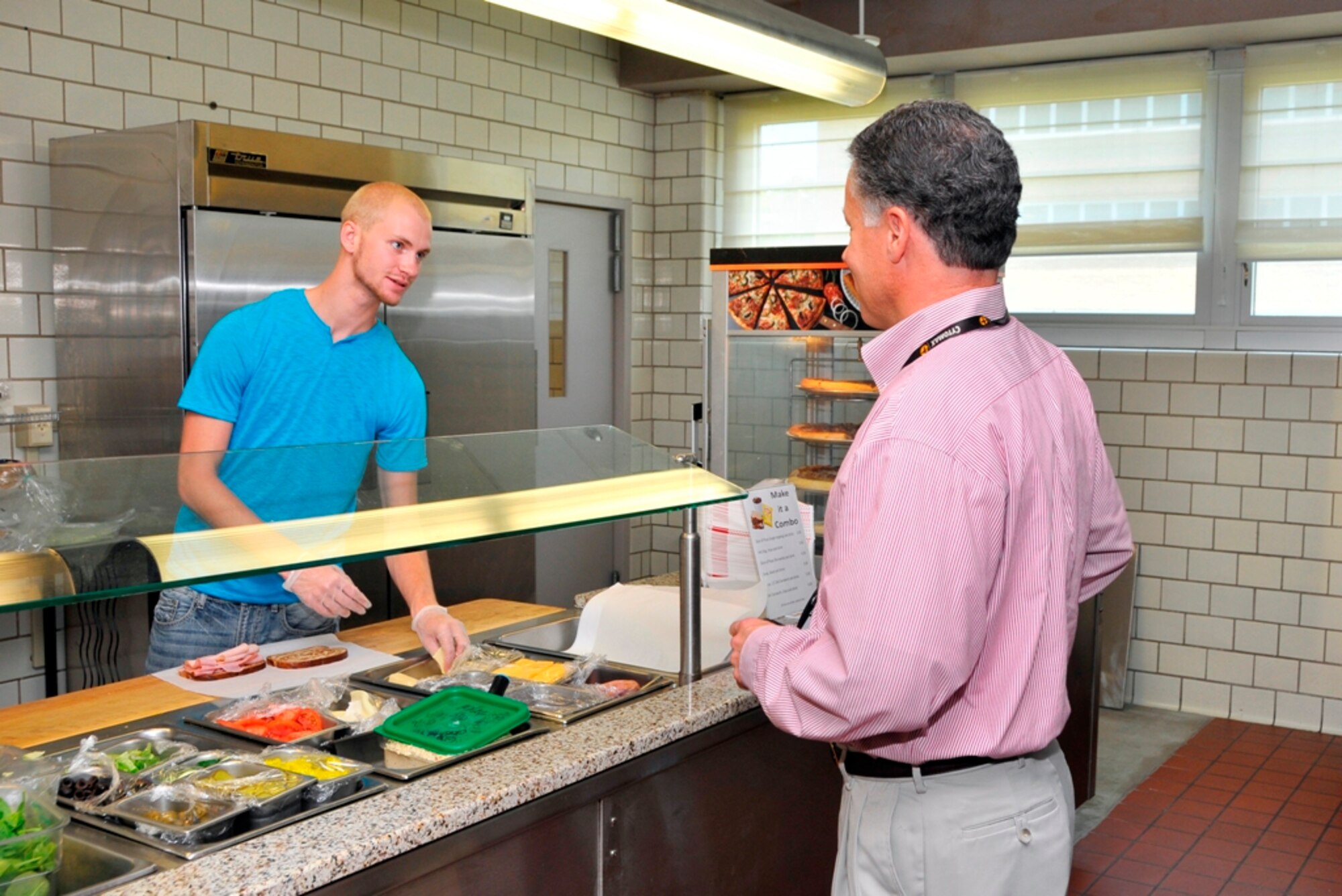 From left, Graham Brandon, with AEDC’s base services, interacts with a customer at the Café 100 in the A&E Building during lunch. (Photo by Jacqueline Cowan)