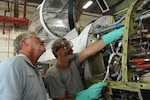 Greg Johnson (left), 12th Flying Training Wing maintenance directorate, and Dennis Williams, 12th Maintenance Directorate corrosion technician, inspect corrosion control work done on a T-6 Texan II on Joint Base San Antonio-Randolph,Texas, July 10. They both wear eye protection to keep foreign objects out of their eyes. (U.S. Air Force photo by Rich McFadden) 