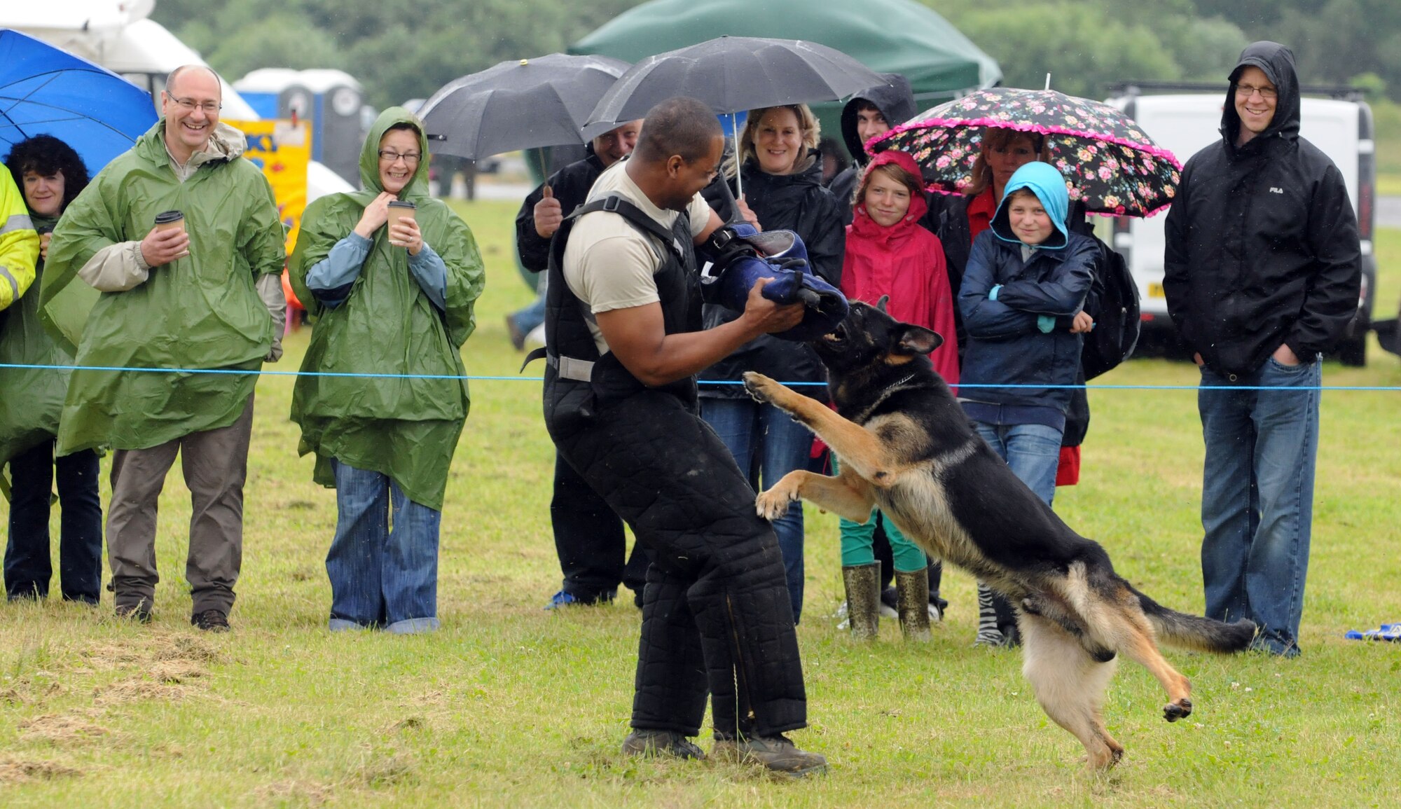 TIBENHAM, England -- Military Working Dog Ferro lunges at K-9 handler Staff Sgt. Billy Lofton, 100th Security Forces Squadron, RAF Mildenhall, during a demonstration at the Tibenham Heritage Air Festival July 8, 2012. The demonstration allowed spectators to see first-hand the abilities of the highly trained animals. (U.S. Air Force photo/Staff Sgt. Austin M. May)