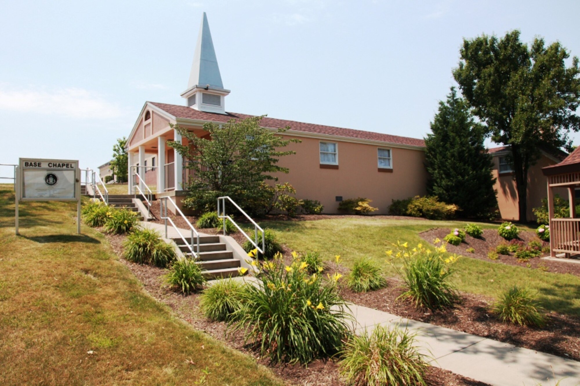 The 911th Airlift Wing Chapel is encircled by bright sunshine and blooming flowers and is conveniently located in the center of the base, June 26, 2012. The chapel is proud to make worship services available during UTAs to all base members. Catholic services are being held on Saturdays at 3:45 p.m., and Protestant worship starts on Sundays at 7:30 a.m. Lunch time bible studies are held weekly as well; Tuesdays study time is reserved for women only, however on Wednesdays both genders are welcome to attend this time of learning and fellowship. Both classes start at 11 a.m. and run about an hour. For more information, please contact the Chaplain’s office at 412-474-8204. (U.S. Air Force photo by Tech. Sgt. Ralph Van Houtem/Released)