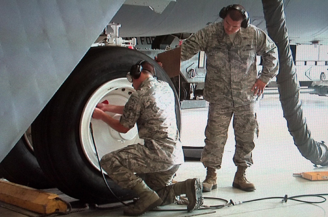 An airman from the 362nd TRS connects a hose to the tire of a B-52 in order to monitor pressure and settings while doing a maintenance check.  The 362nd TRS B-52 Aerospace Maintenance Apprentice course teaches airmen the fundamentals of becoming a B-52 Crew Chief.  (U.S. Air Force Photo/Josh Wilson)