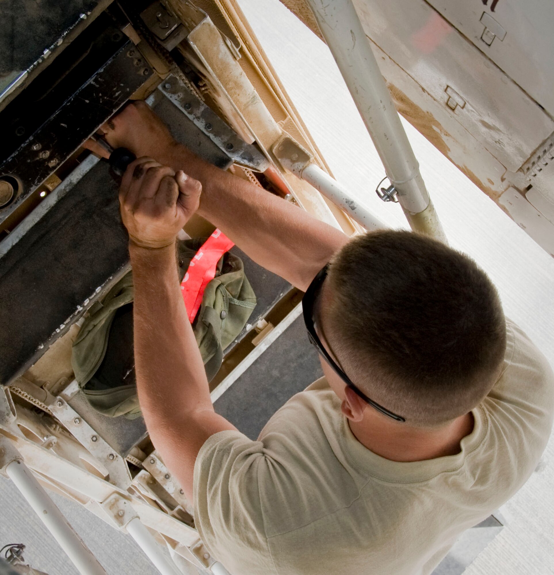 Senior Airman Kenneth Auchenbach, 379th Expeditionary Maintenance Squadron aircrew egress systems journeyman, conducts maintenance on ballistic components for the B1-Lancer as he stands half way up the crew ladder July 6, 2012.  The four-man B-1 egress team maintains the ejection seats, hatches and crew ladder for the Lancer. (U.S. Air Force photo/Senior Airman Bryan Swink)