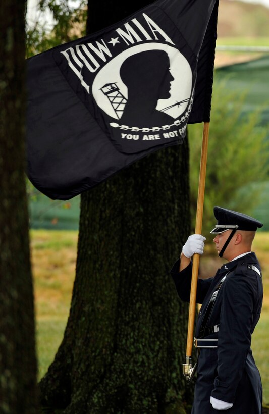 A U.S. Air Force Honor Guard ceremonial guardsman marches with the POW/MIA flag during a funeral at Arlington National Cemetery in Arlington, Va. on July 9. The funeral laid to rest the remains of the six Airmen who went missing when their Douglas AC-47 Spooky gunship crashed in Laos on Christmas Eve 1965 during a Vietnam combat mission. The Airmen were buried in Arlington after being identified through dental records, personal items and other circumstantial evidence. (U.S. Air Force photo/Senior Airman Perry Aston)