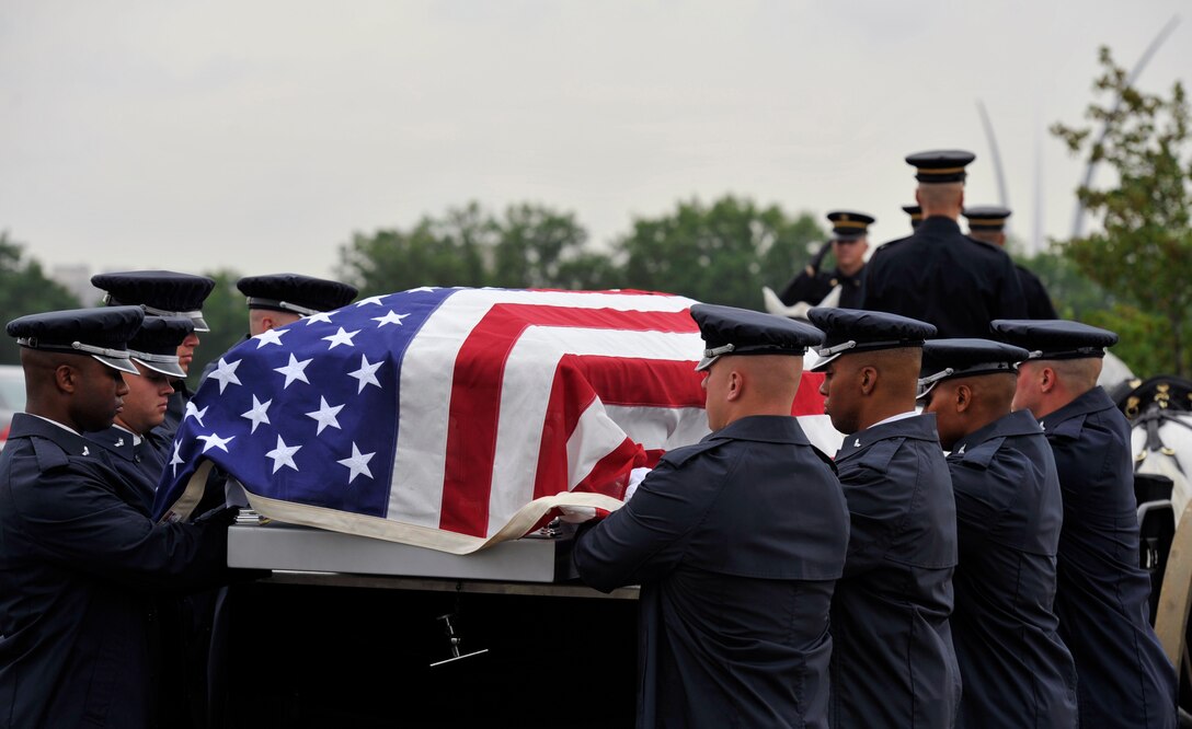 Airmen from the U.S. Air Force Honor Guard participate in a transfer ceremony during a funeral on July 9 at Arlington National Cemetery in Arlington, Va. The funeral laid to rest the remains of the six Airmen who went missing when their Douglas AC-47 Spooky Gunship crashed in Laos on Christmas Eve 1965 during a Vietnam combat mission. The Airmen were buried in Arlington after being identified through dental records, personal items and other circumstantial evidence. (U.S. Air Force photo/Senior Airman Perry Aston)