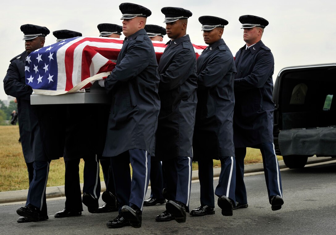 Airmen from the U.S. Air Force Honor Guard participate in a transfer ceremony during a funeral on July 9 at Arlington National Cemetery in Arlington, Va. The funeral laid to rest the remains of the six Airmen who went missing when their Douglas AC-47 Spooky Gunship crashed in Laos on Christmas Eve 1965 during a Vietnam combat mission. The Airmen were buried in Arlington after being identified through dental records, personal items and other circumstantial evidence. (U.S. Air Force photo/ Senior Airman Perry Aston)