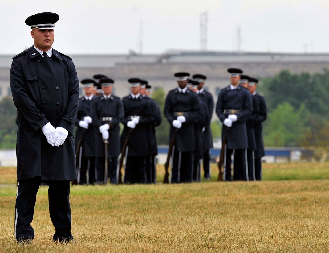 Airmen from the U.S. Air Force Honor Guard participate in a transfer ceremony during a funeral on July 9 at Arlington National Cemetery in Arlington, Va. The funeral laid to rest the remains of the six Airmen who went missing when their Douglas AC-47 Spooky Gunship crashed in Laos on Christmas Eve 1965 during a Vietnam combat mission. The Airmen were buried in Arlington after being identified through dental records, personal items and other circumstantial evidence. (U.S. Air Force photo/Senior Airman Perry Aston)