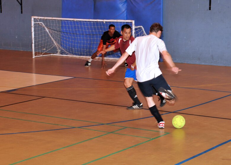 RAF MILDENHALL, England – Darren Odey, 100th Civil Engineer Squadron, takes a shot during an Intramural Indoor Soccer match against the 100th Security Forces Squadron at the North Side Fitness Center July 10, 2012. The CES emerged victorious with a final score of 8-4. (U.S. Air Force photo/Senior Airman Jerilyn Quintanilla)
