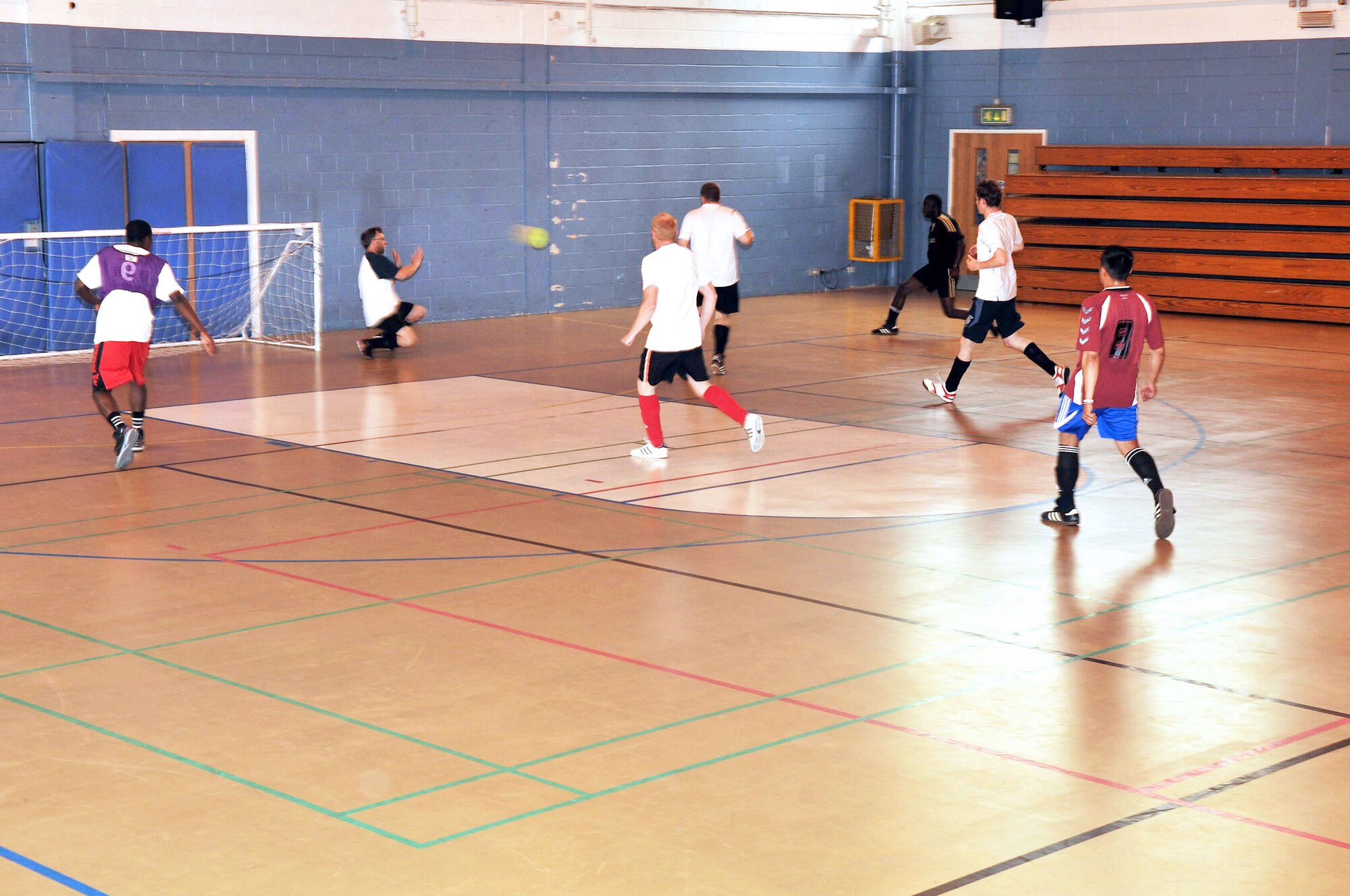 RAF MILDENHALL, England – Barry King, 100th Civil Engineer Squadron goalie, prepares to block a shot during an Intramural Indoor Soccer match against the 100th Security Forces Squadron at the North Side Fitness Center July 10, 2012. Currently, the league consists of eight teams from the various squadrons on base. (U.S. Air Force photo/Senior Airman Jerilyn Quintanilla)