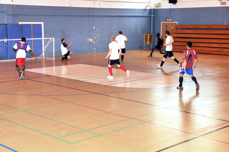 RAF MILDENHALL, England – Barry King, 100th Civil Engineer Squadron goalie, prepares to block a shot during an Intramural Indoor Soccer match against the 100th Security Forces Squadron at the North Side Fitness Center July 10, 2012. Currently, the league consists of eight teams from the various squadrons on base. (U.S. Air Force photo/Senior Airman Jerilyn Quintanilla)