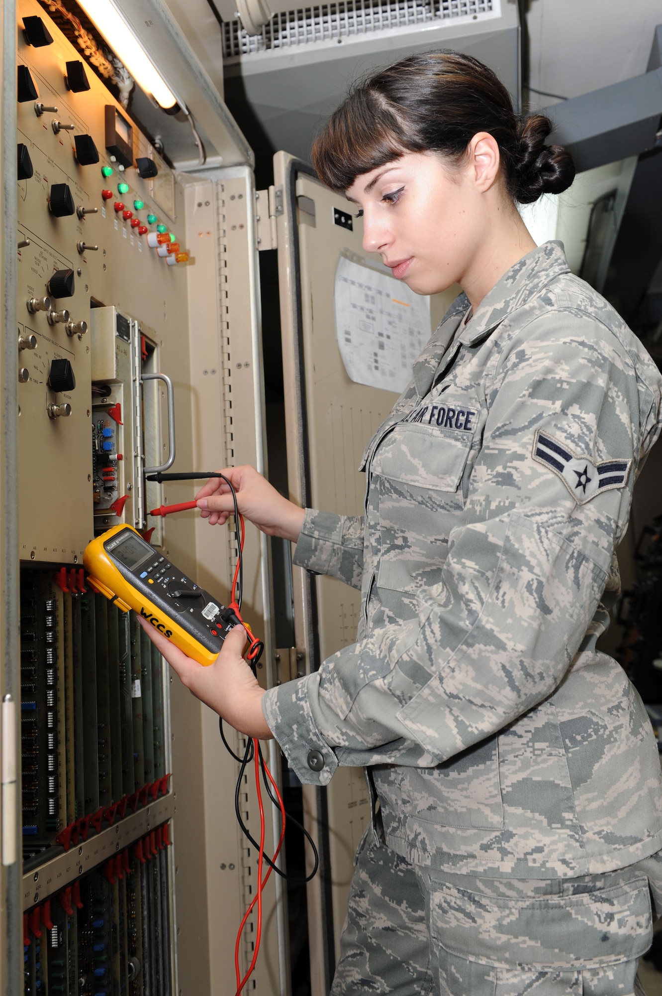 SPANGDAHLEM AIR BASE, Germany – Airman 1st Class Megan McMillan, 52nd Communications Squadron ground radar systems technician, checks the voltage on a radar processor power supply using a digital volt meter at the ground radar maintenance shop here July 10. The inspection ensures the correct voltage is being distributed throughout the processor. Ground radar systems provide data used by air traffic controllers to manage Spangdahlem air space for U.S. and NATO aircraft. (U.S. Air Force photo by Senior Airman Christopher Toon/Released)