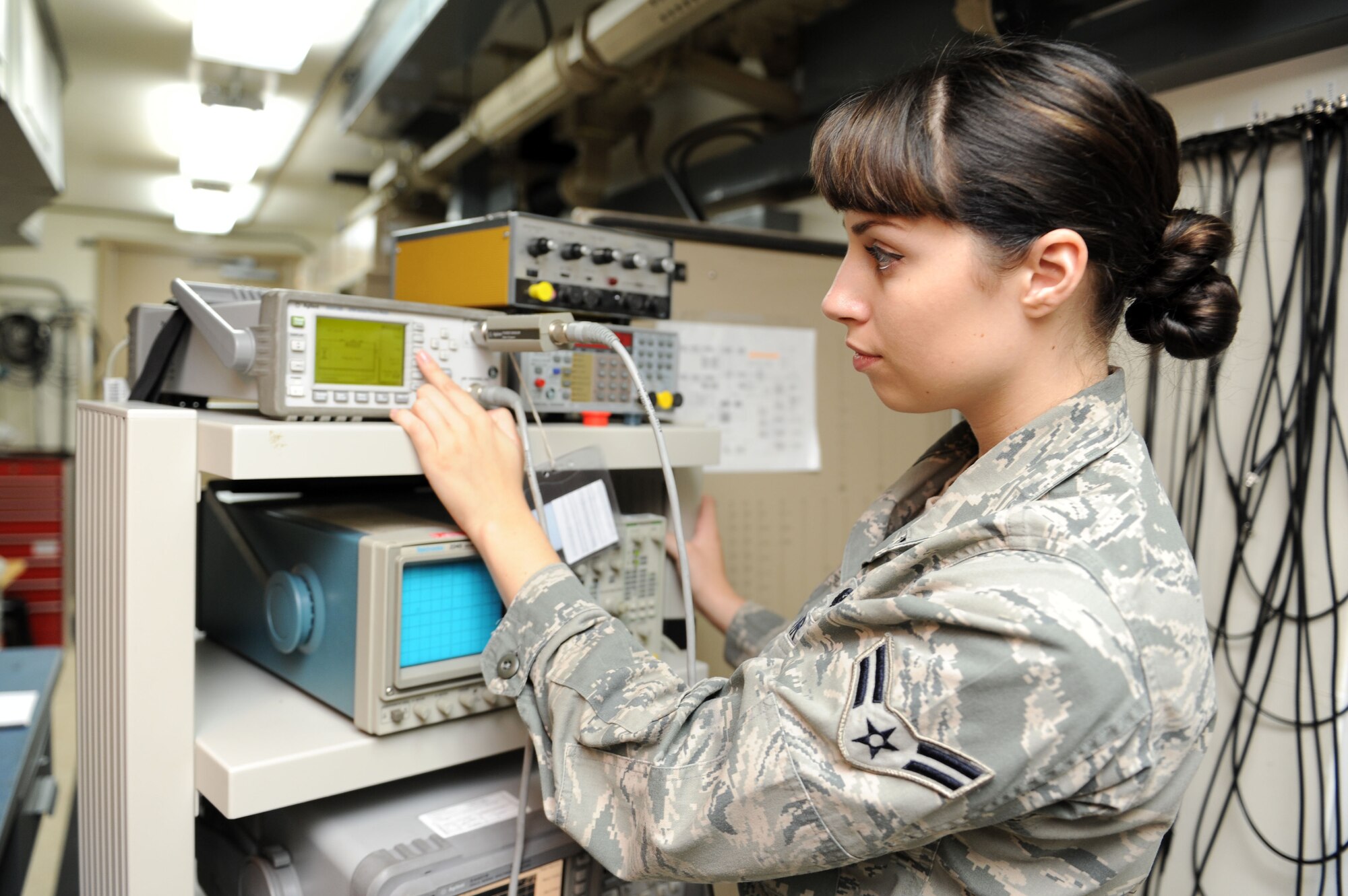 SPANGDAHLEM AIR BASE, Germany – Airman 1st Class Megan McMillan, 52nd Communications Squadron ground radar systems technician, checks the output of power using a power meter at the ground radar maintenance shop here July 10. The inspection ensures the radar is putting out the right amount of power and running to the best of its capabilities. Ground radar systems provide data used by air traffic controllers to manage Spangdahlem air space for U.S. and North Atlantic Treaty Organization aircraft. (U.S. Air Force photo by Senior Airman Christopher Toon/Released)