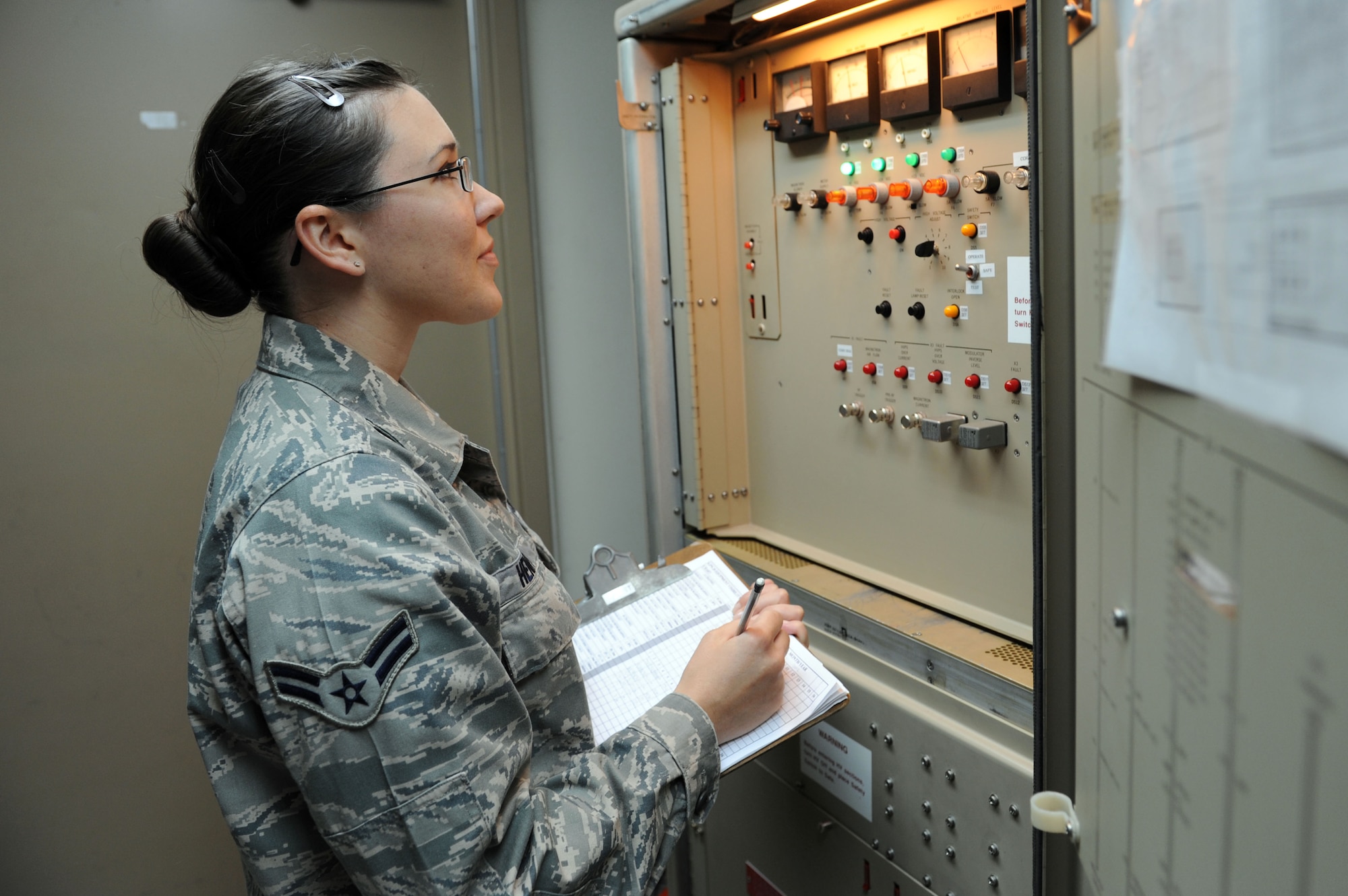 SPANGDAHLEM AIR BASE, Germany – Airman 1st Class Rachel Henry, 52nd Communications Squadron ground radar systems technician, performs a daily preventive maintenance inspection meter reading on a radar transmitter at the ground radar maintenance shop here July 10. The reading is checked to ensure the radar is working properly. Ground radar systems provide data used by air traffic controllers to manage Spangdahlem air space for U.S. and NATO aircraft. (U.S. Air Force photo by Senior Airman Christopher Toon/Released)